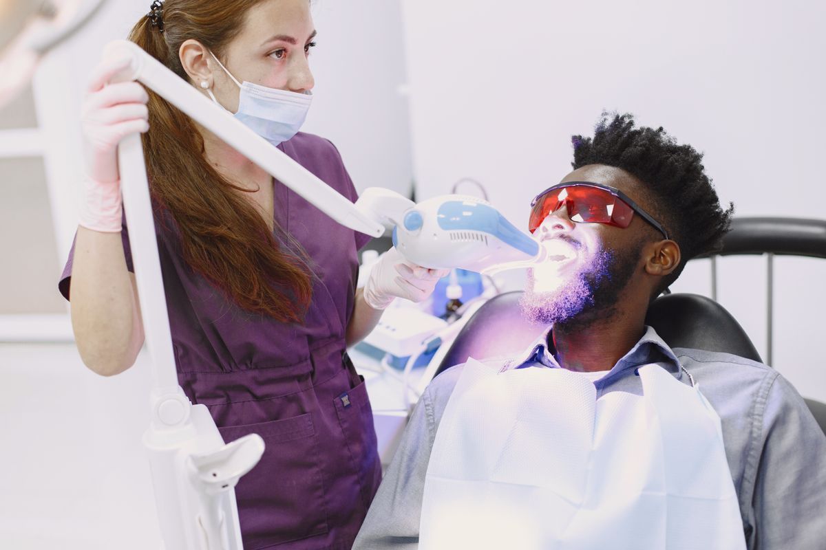 Illustrative patient relaxing during a professional whitening session, not the actual clinic